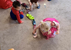 Dzieci podczas zabaw Andrzejkowych z butami.